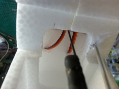 there weren't any holes for the servo leads, so I punched a few in!