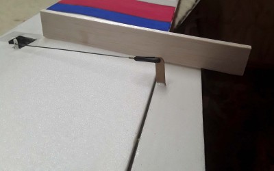 Set up the Clovis, set servo to neutral on the radio, apiece of balsa to set the elevon level with the lower wing, then add glue to the slot and horn and stick with elevon in the correct alignment.